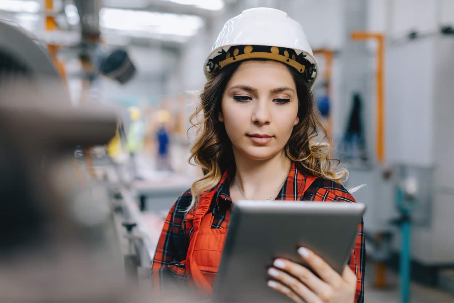 A lady engineer looking at tablet in company