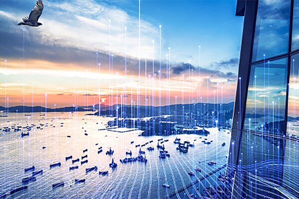 Aerial view of a sea coast in the evening overlaid with graphics of transmission of nodes