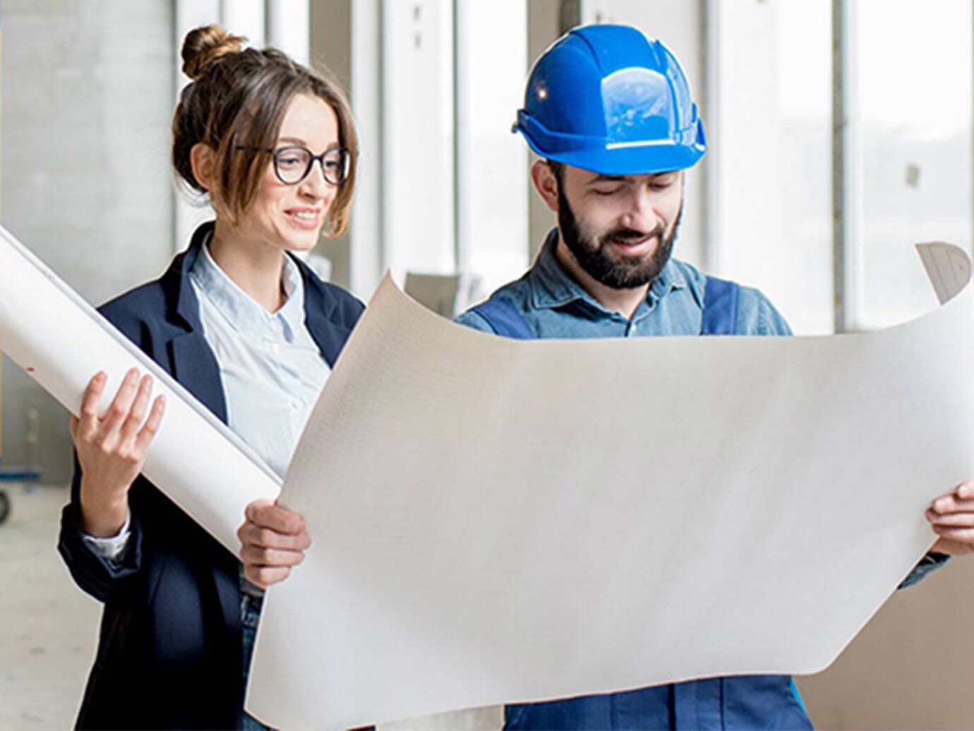 Male and female engineer discussion blueprint in site