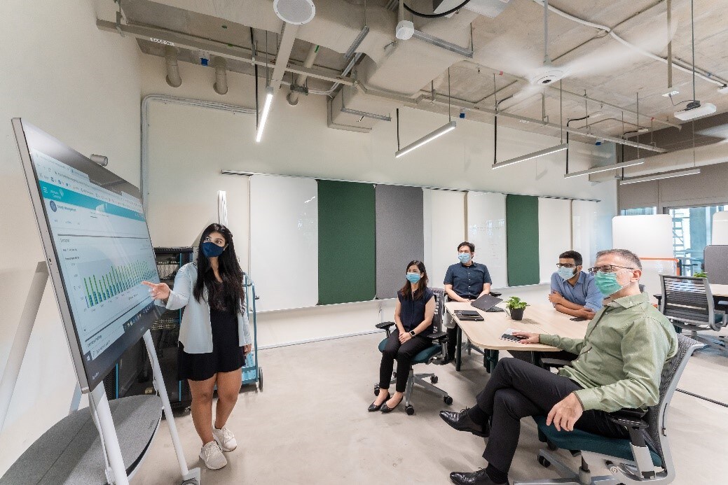Office Meeting Room with Employees in Discussion