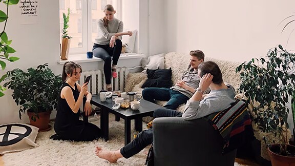 Group of friends casually chatting in the living room