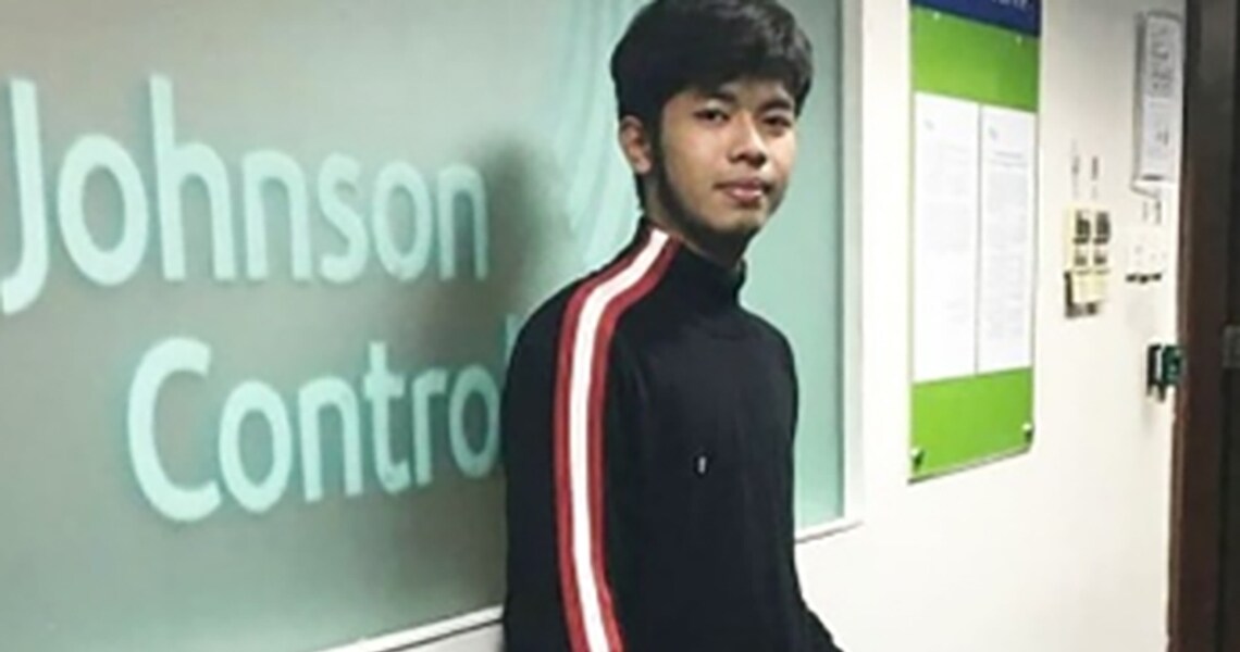 A young boy standing infront of projector displaying Johnson Controls in the meeting room 