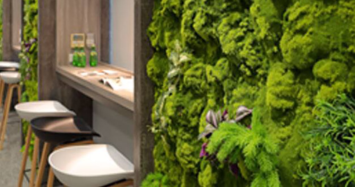 Cafe area with high chairs and Moss wall decor