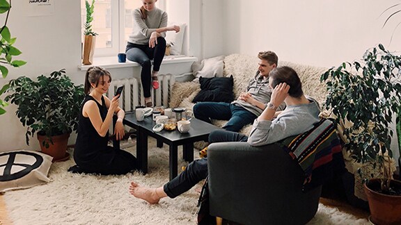 A group of friends casually chatting in the living room