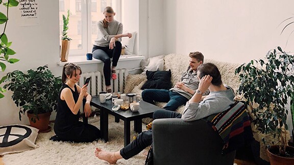 Group of friends casually chatting in the living room
