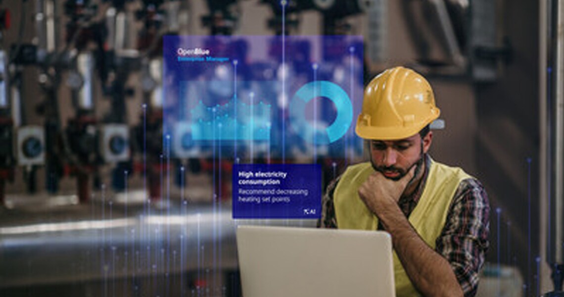 Man with safety Cap using a laptop