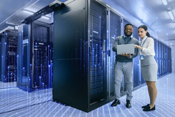 Two employees with laptop in a data center overlaid with graphics of transmission nodes