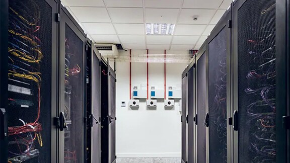 Interior view of a datacenter with rows of server racks