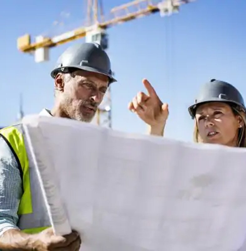 Two architects in uniform at site work