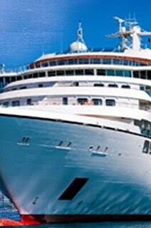 Cargo ship sailing in open sea with a cruise ship besides