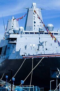 A naval ship docked near to a port