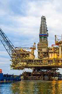 A ship docked near to a petrochemical plant