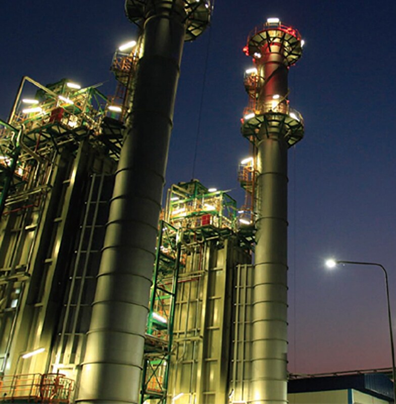Bottom up view of a power plant at night