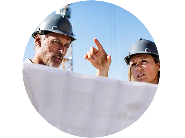 Two technicians, working on the site while looking at the blue print