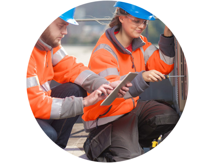 Two technicians, working on-site on the mechanical system