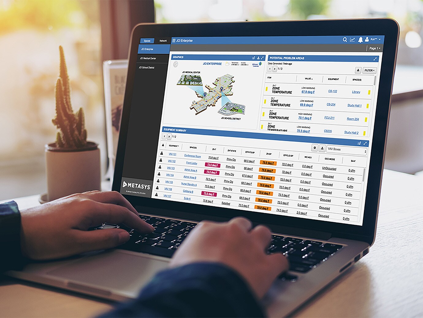 Close-up hands working on laptop