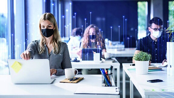 Professionals wearing masks and working in an office overlaid with graphics of transmission nodes