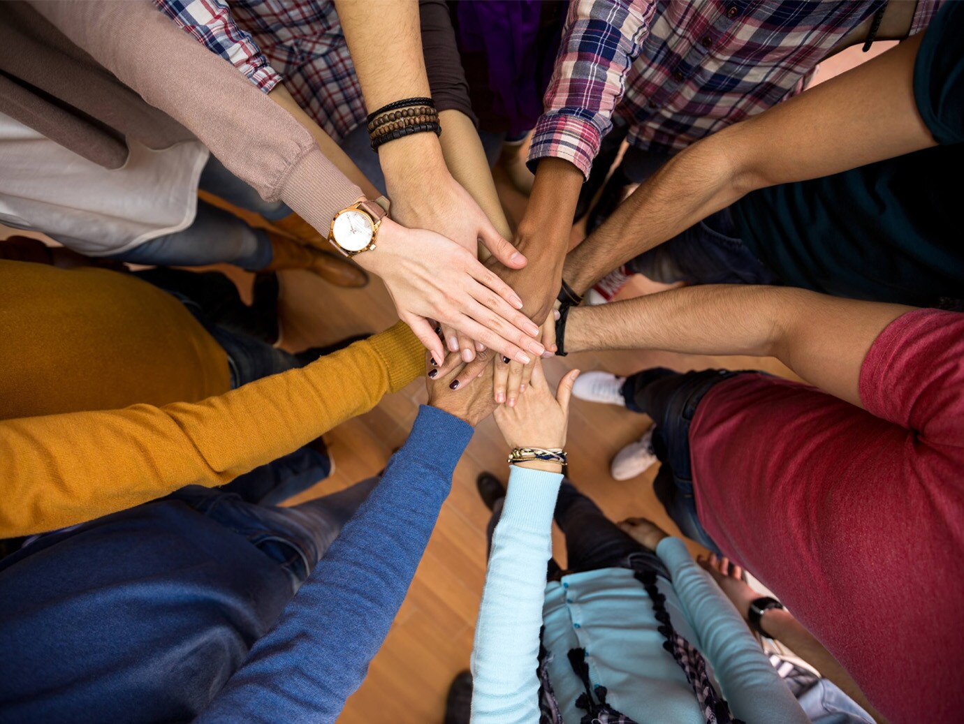 Close-up of a group of people with their hands stacked together