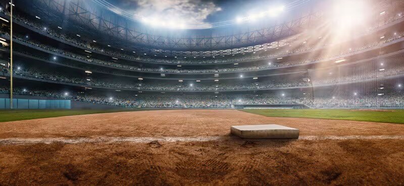 Interior view of a baseball field lit up in the night