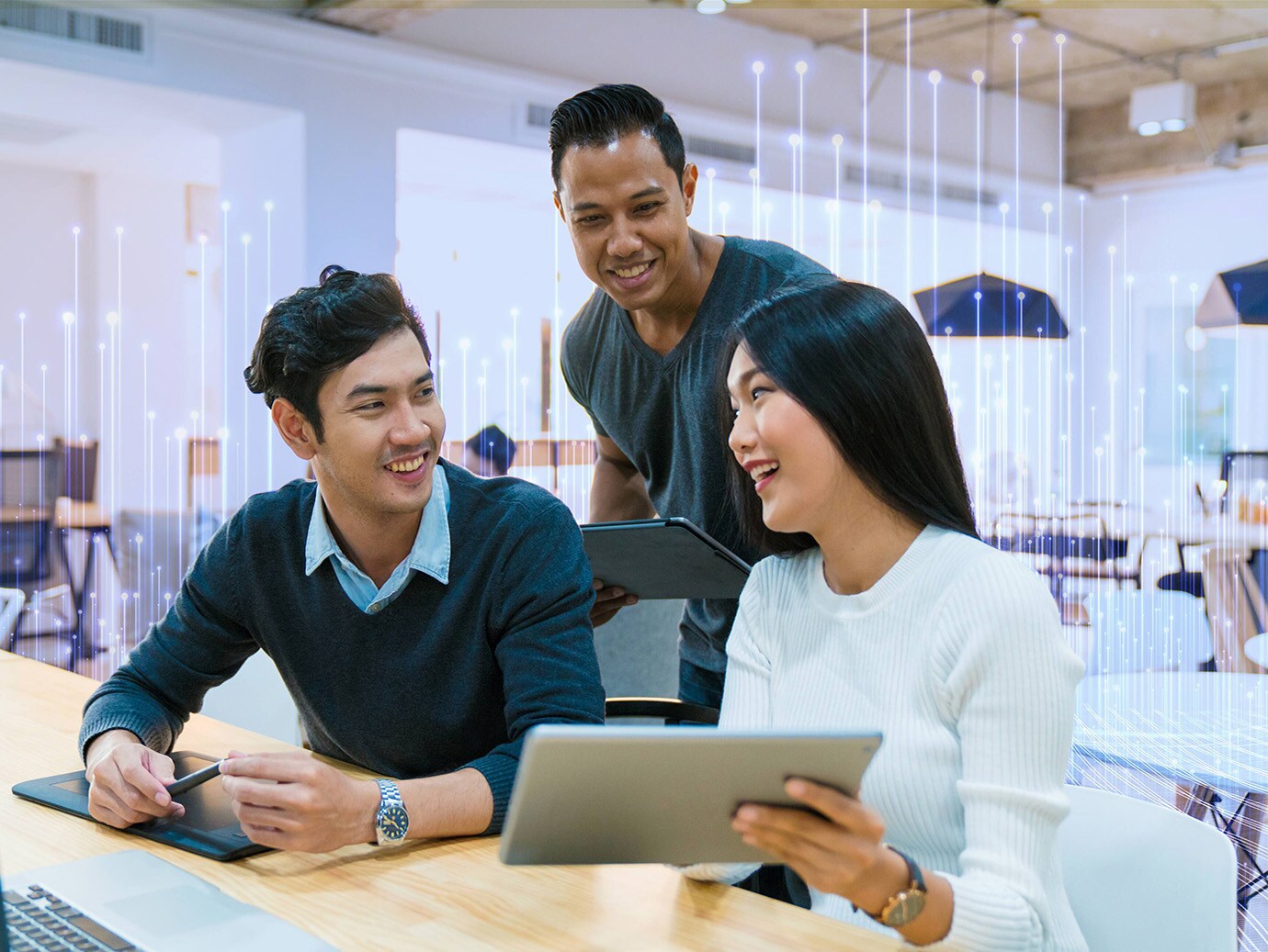 Three employees in a happy conversation at workplace overlaid with graphics of transmission nodes