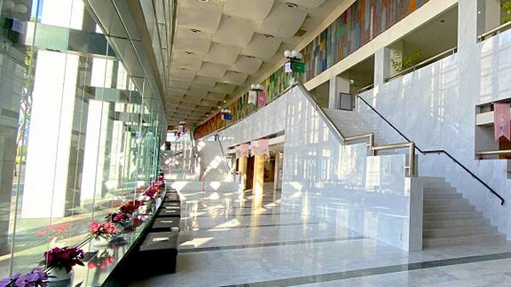 The building's lobby showcases a grand staircase