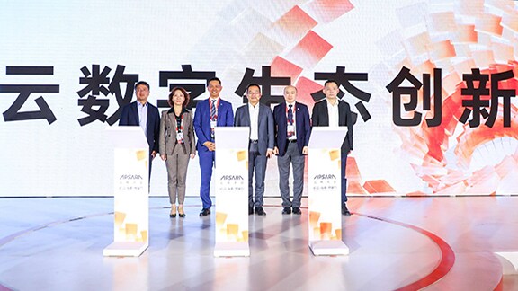 Four individuals standing on a podium