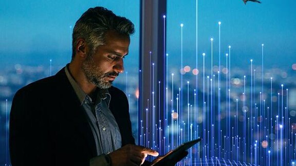 A man using a tab with openblue background