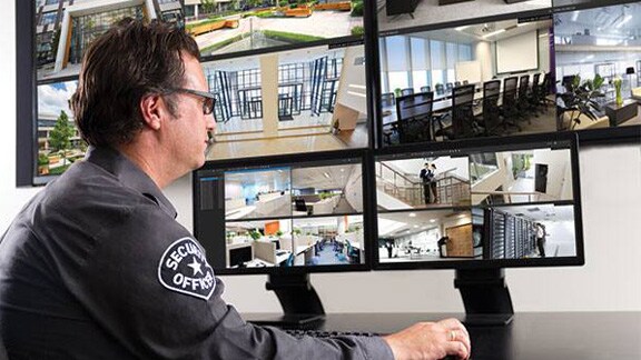 Security personnel monitoring the CCTV footages on the monitor in the control room