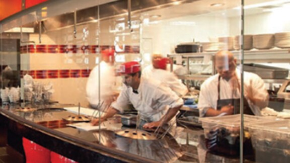 Open restaurant kitchen with chefs working 
