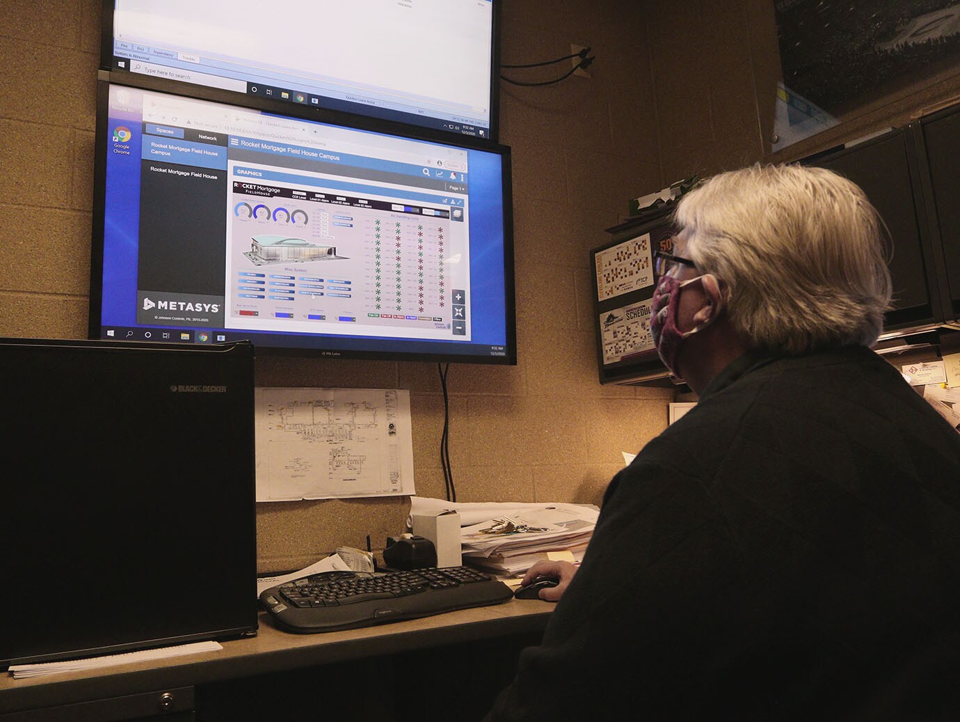 Man in face mask working on a computer