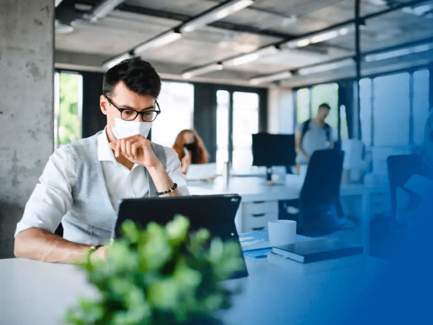 Man wearing face mask working in office