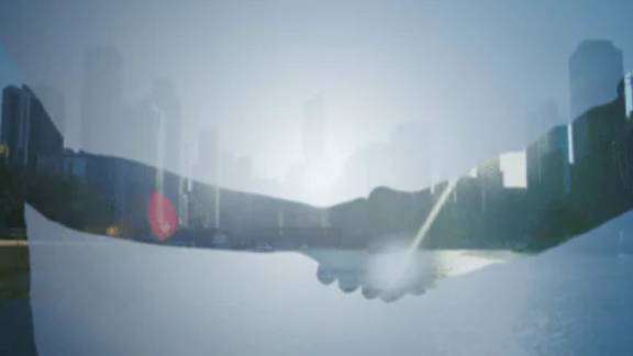 Two businessmen shaking hands over a deal