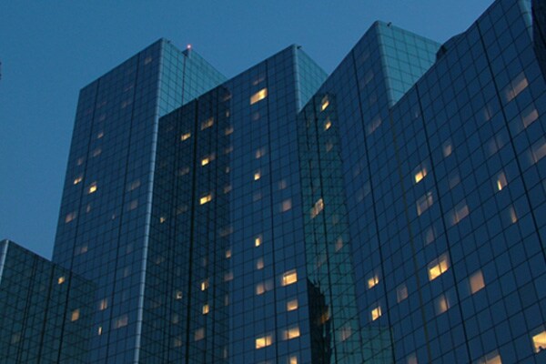Upwards shot of a skyscraper with glass windows at dusk