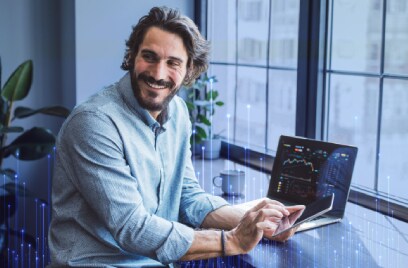 A smiling man at his workstation in office, overlaid with a graphic of transmission nodes
