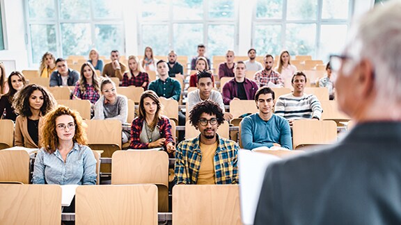 University students listening to a professor's lecture