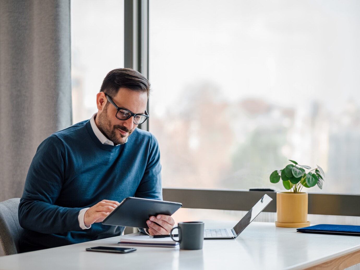 A man on laptop and tablet