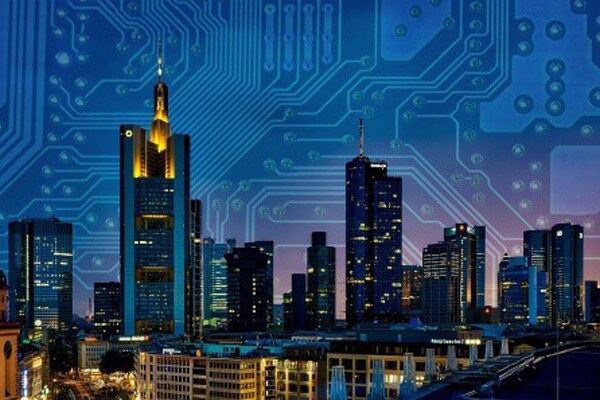 View of a cityscape in the night overlaid with electric circuit grid in the background 
