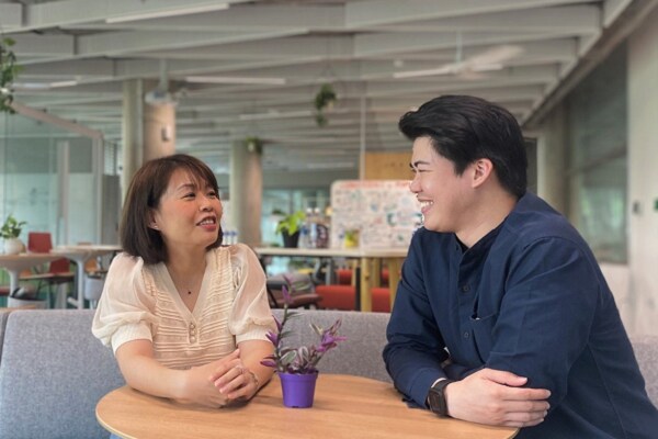 Two employees discussing coffee table